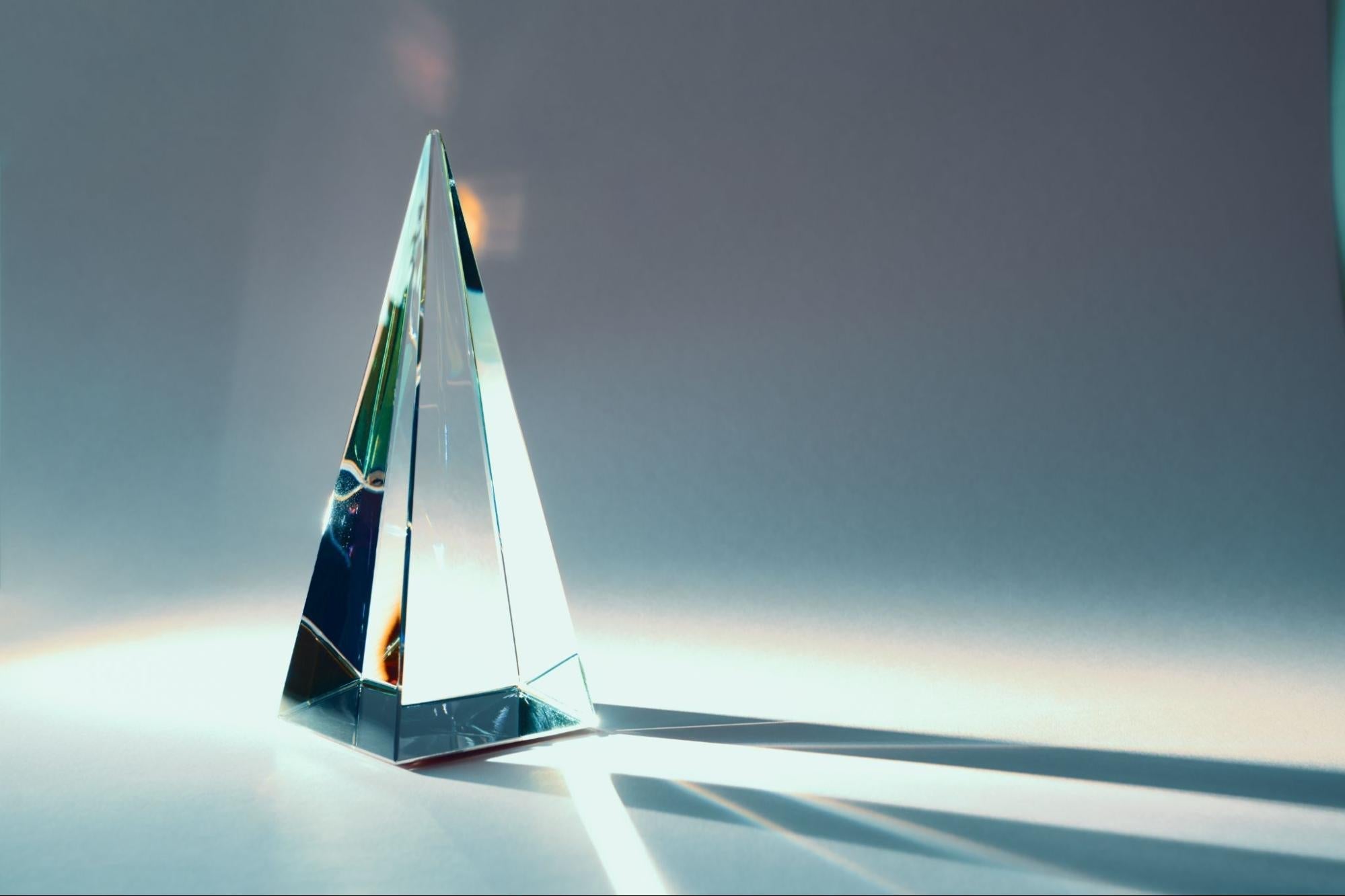 Modern glass corporate award on a clean office desk, minimalist recognition gift for business teams.